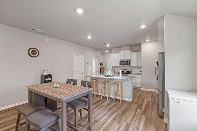 7706 Iron Man, Corpus Christi, TX 78414 - dining area with baseboards, recessed lighting, visible vents, and light wood-style floors