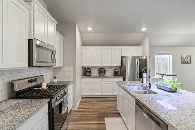 7706 Iron Man, Corpus Christi, TX 78414 - kitchen with recessed lighting, wood finished floors, a sink, white cabinetry, and appliances with stainless steel finishes