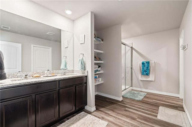7706 Iron Man, Corpus Christi, TX 78414 - bathroom with wood finished floors, a sink, visible vents, double vanity, and a stall shower