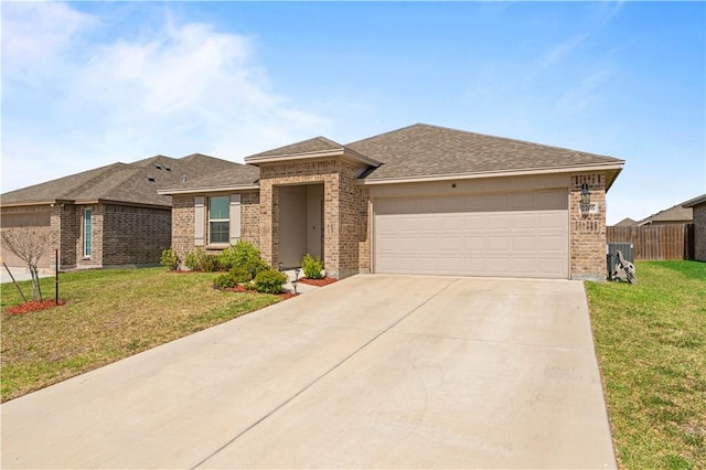 view of front of home with an attached garage, brick siding, fence, concrete driveway, and a front yard