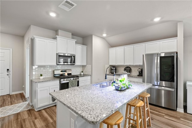 7706 Iron Man, Corpus Christi, TX 78414 - kitchen featuring appliances with stainless steel finishes, a sink, visible vents, and light wood-style floors