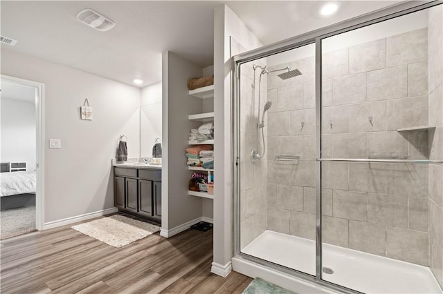7706 Iron Man, Corpus Christi, TX 78414 - ensuite bathroom with wood finished floors, vanity, visible vents, baseboards, and a stall shower