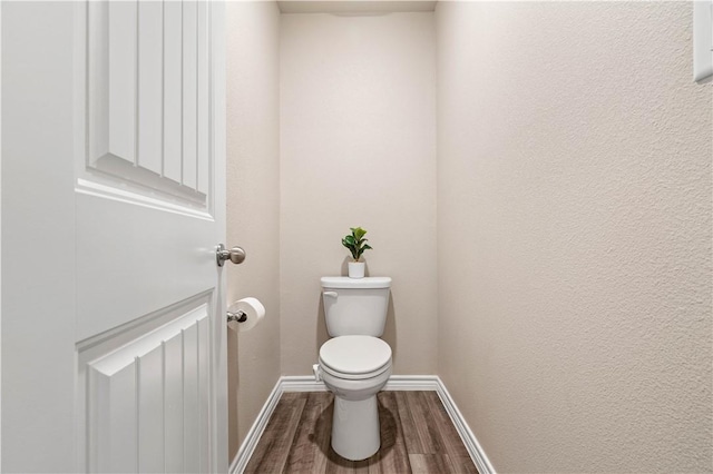 7706 Iron Man, Corpus Christi, TX 78414 - bathroom with a textured wall, wood finished floors, toilet, and baseboards
