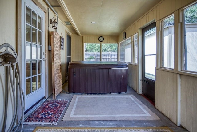 unfurnished sunroom with visible vents and a jacuzzi