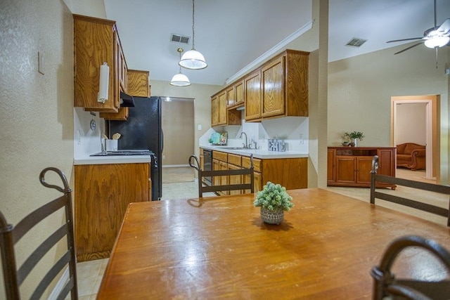 kitchen featuring a sink, visible vents, and brown cabinets