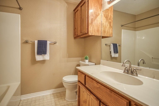 bathroom with baseboards, vanity, toilet, and tile patterned floors