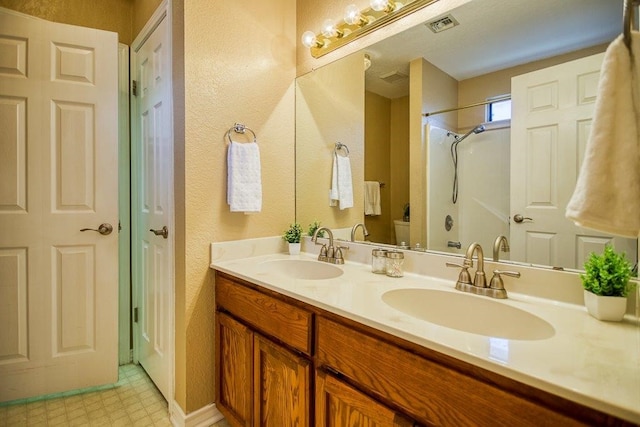 bathroom with toilet, a sink, visible vents, and tile patterned floors