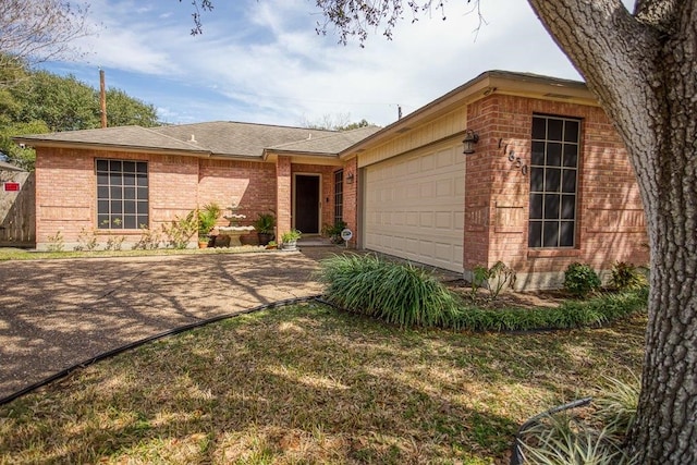 ranch-style house featuring a garage, driveway, brick siding, and a shingled roof