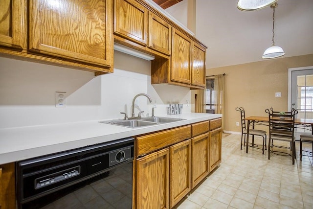 kitchen featuring brown cabinets, light countertops, hanging light fixtures, a sink, and dishwasher