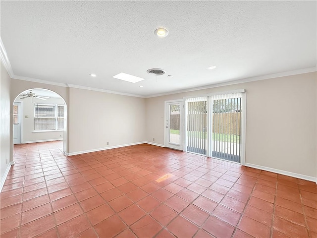 spare room with ornamental molding, visible vents, light tile patterned floors, and a textured ceiling