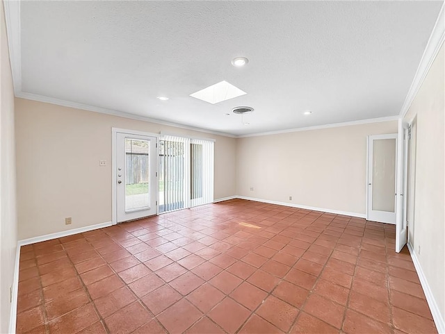 spare room with a skylight, baseboards, ornamental molding, and visible vents