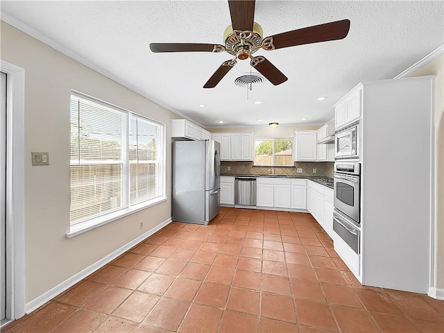kitchen with tasteful backsplash, a ceiling fan, visible vents, appliances with stainless steel finishes, and dark countertops