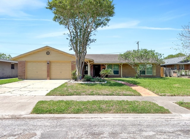 view of front of house featuring brick siding, driveway, a front lawn, and a garage