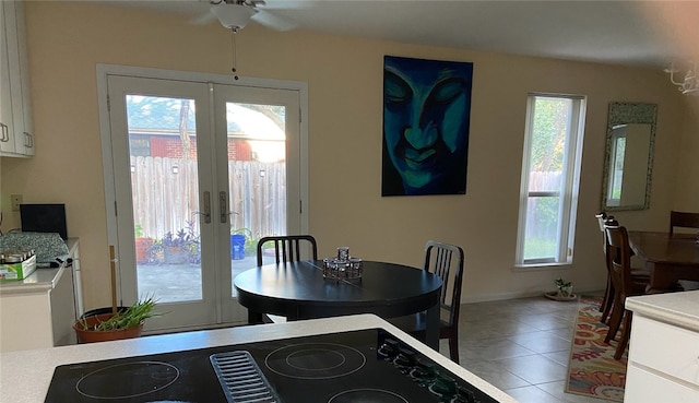 dining room with french doors, tile patterned flooring, and ceiling fan