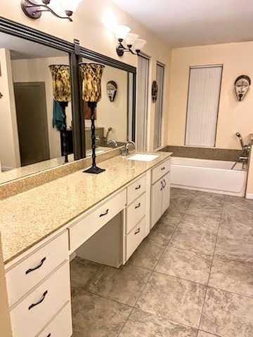 bathroom with vanity and a bathing tub