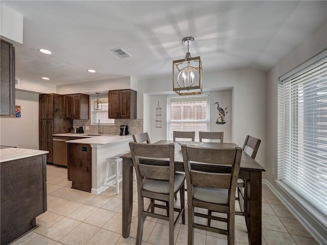 dining space featuring light tile patterned floors, recessed lighting, and a chandelier