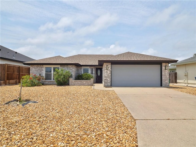 single story home featuring brick siding, fence, a garage, and concrete driveway