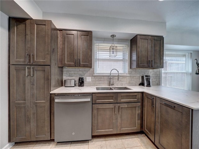 kitchen with dishwasher, a sink, a peninsula, and healthy amount of natural light