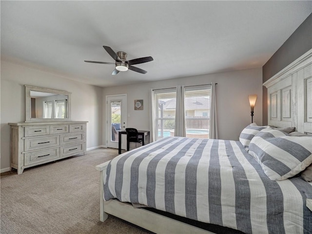 bedroom featuring access to outside, baseboards, light colored carpet, and a ceiling fan