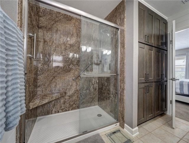 hallway with light carpet, light tile patterned floors, and baseboards