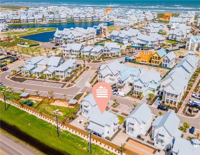 drone / aerial view with a water view and a residential view