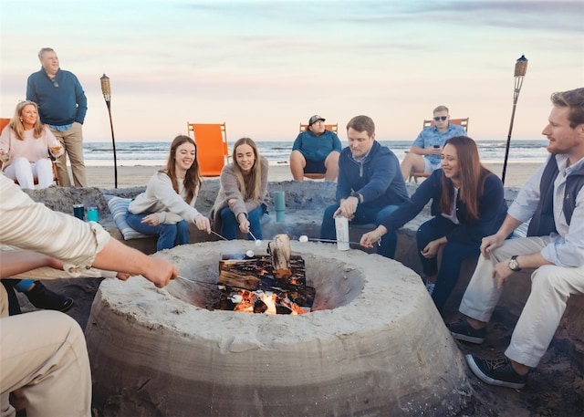 details with a beach view and a fire pit