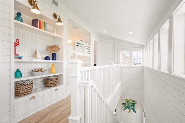 interior space with lofted ceiling, wood finished floors, and visible vents