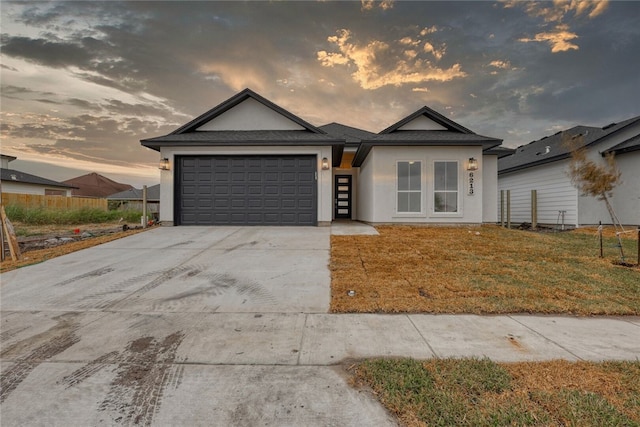 view of front of house with a garage and a yard