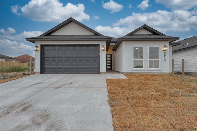 ranch-style house featuring a garage and a front yard