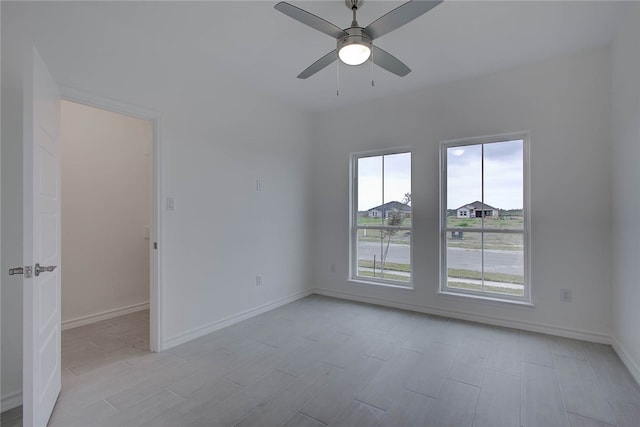 unfurnished room with light wood-type flooring and ceiling fan