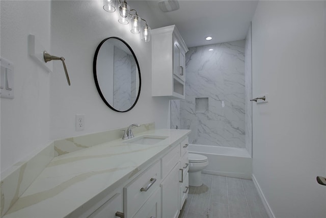 full bathroom featuring vanity, tiled shower / bath combo, and toilet