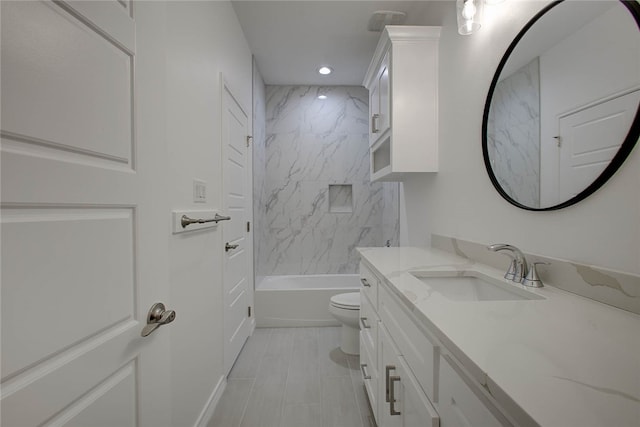 full bathroom with vanity, toilet, and tiled shower / bath combo