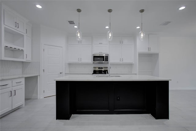 kitchen featuring white cabinets, a kitchen island with sink, and stainless steel appliances