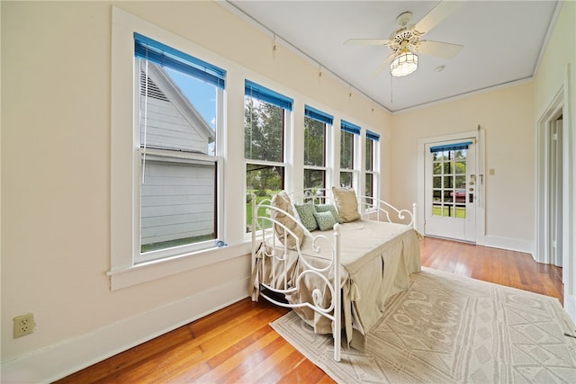 sunroom / solarium featuring ceiling fan and a healthy amount of sunlight