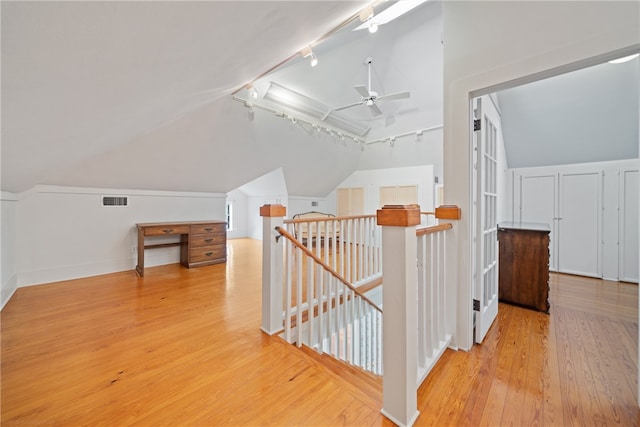 additional living space with ceiling fan, light wood-type flooring, and lofted ceiling