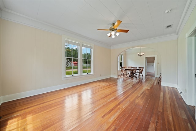 interior space with ceiling fan with notable chandelier, hardwood / wood-style flooring, and crown molding