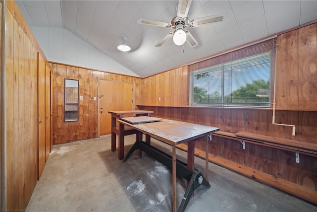 interior space featuring ceiling fan, wooden walls, and lofted ceiling