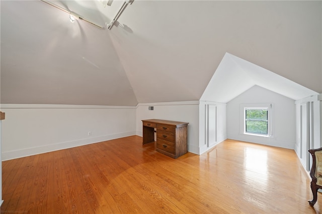 bonus room featuring light hardwood / wood-style floors and vaulted ceiling