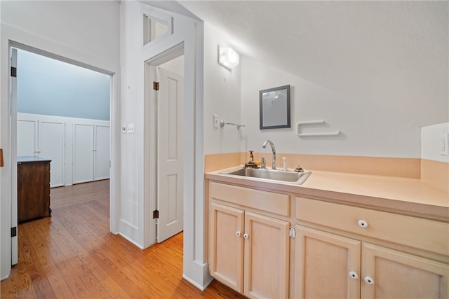 bathroom with hardwood / wood-style floors and sink