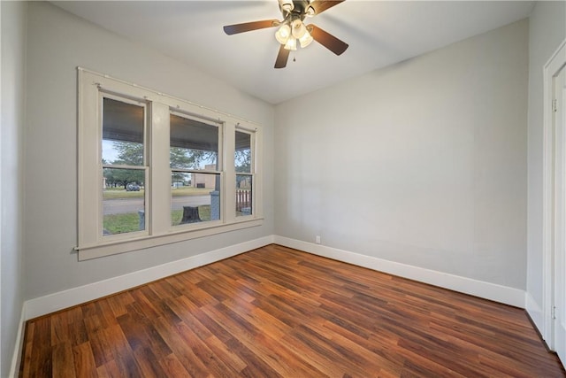 empty room with ceiling fan and dark hardwood / wood-style floors