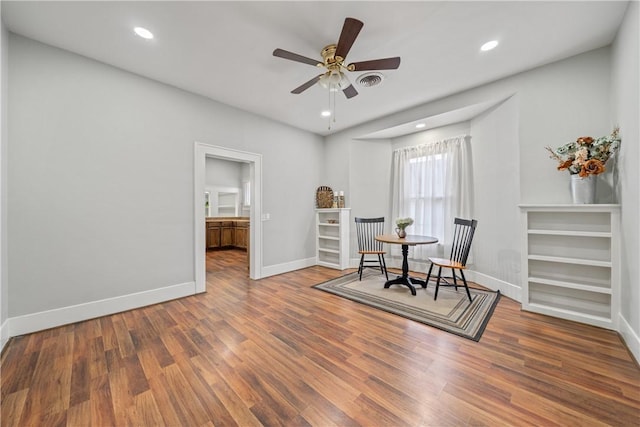 sitting room with ceiling fan and dark hardwood / wood-style floors