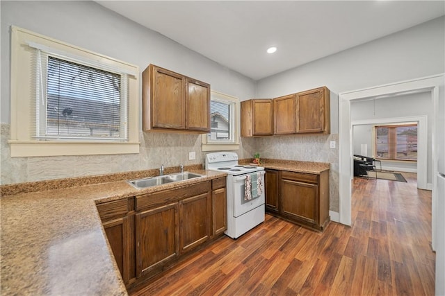 kitchen featuring sink, white electric range, plenty of natural light, and dark hardwood / wood-style floors