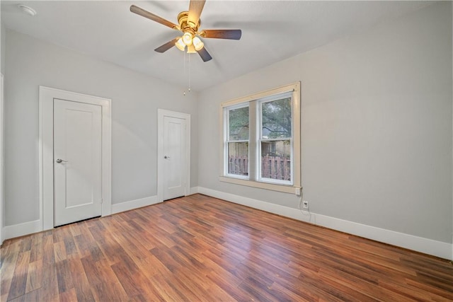 unfurnished room with ceiling fan and dark hardwood / wood-style floors