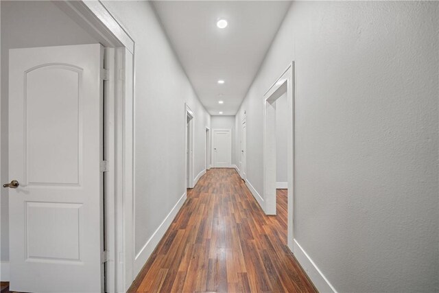 corridor with dark hardwood / wood-style floors