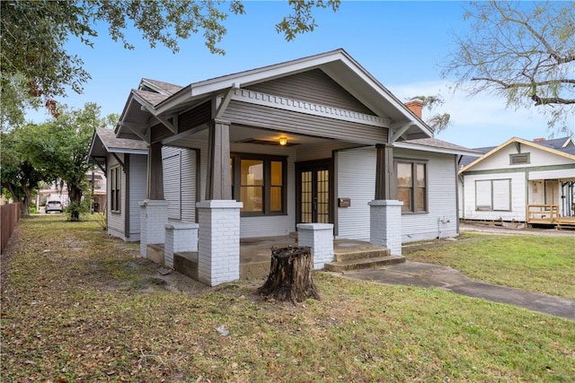 view of front facade featuring french doors and a front lawn