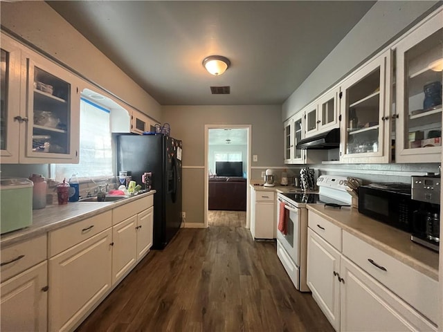 kitchen with light countertops, visible vents, under cabinet range hood, and black appliances