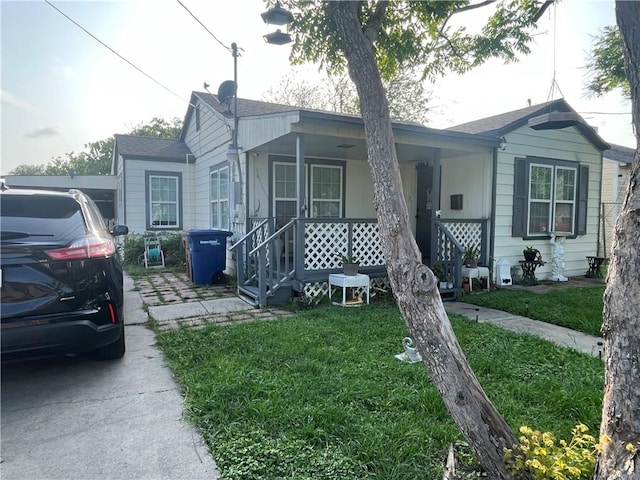 view of front of home featuring a front yard and covered porch