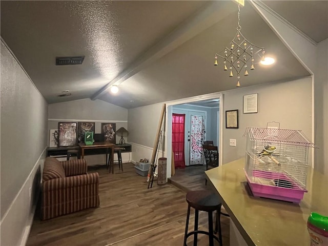interior space with lofted ceiling, a chandelier, and wood finished floors