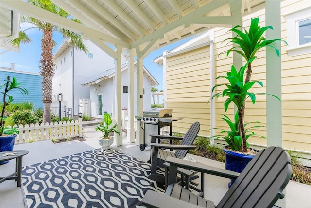 view of patio with grilling area and fence