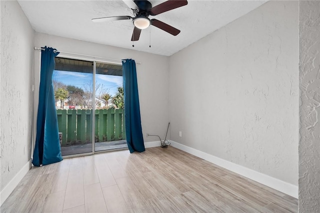 spare room featuring ceiling fan and light hardwood / wood-style flooring